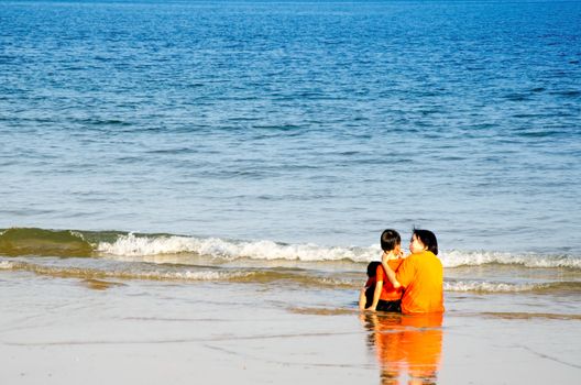 Happy Young Family Having Fun on Beach