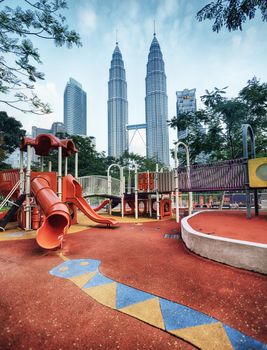 KUALA LUMPUR, MALAYSIA -Jun 10 : Petronas Towers view from Kuala Lumpur City Centre Park on Jun 10, 2014 in Kuala Lumpur, Malaysia. KLCC Park is a public park located in the vicinity of Suria KLCC, Kuala Lumpur, Malaysia. The park has been designed to provide greenery to Petronas Twin Towers and the areas surrounding it.