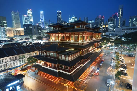 Buddha Toothe Relic Temple in Chinatown with Singapore`s business district in the background.