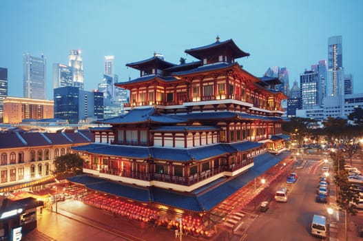 Buddha Toothe Relic Temple in Chinatown with Singapore`s business district in the background.