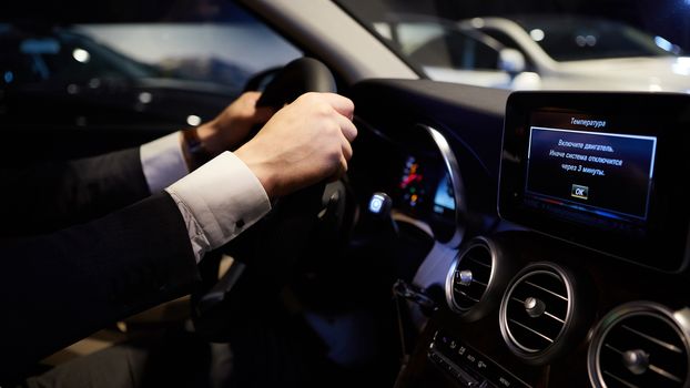 Closeup of hands on a steering wheel