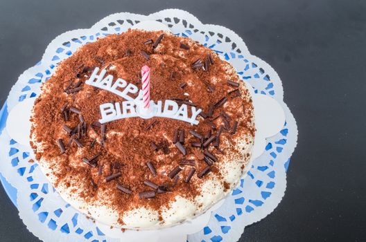 Birthday cake with candle and inscription Happy Birthday