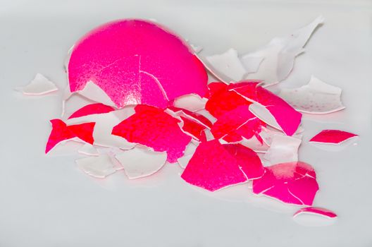 Eggshell against white background of a red Easter egg.