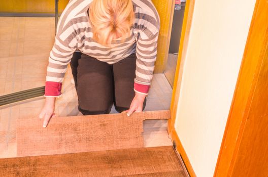 Laying of floor covering. Here processing of vinyl laminate floor in the old building.