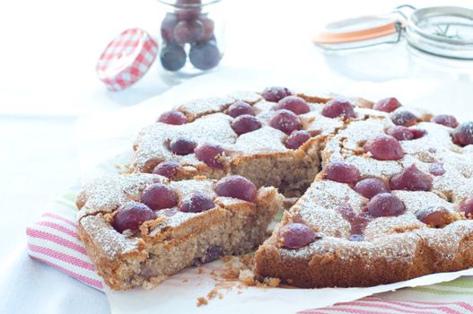 Fresh cake with red grape season and icing sugar