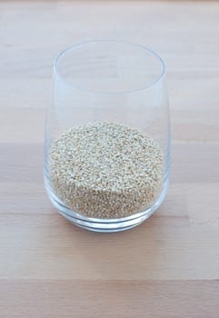 Filling a glass of quinoa grain from the Andes