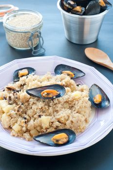 Warm quinoa salad with mussels, tomatoes and potatoes