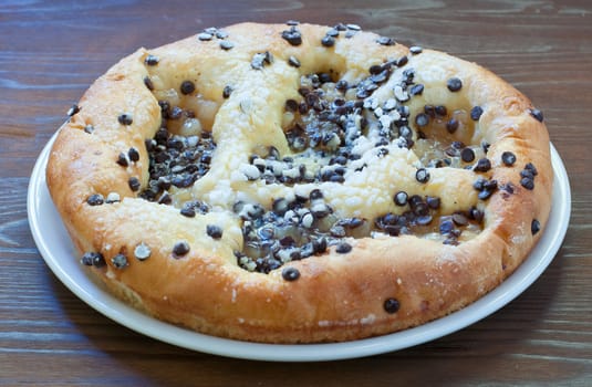 Sweet cake with chocolate chunks, cheese and powdered sugar