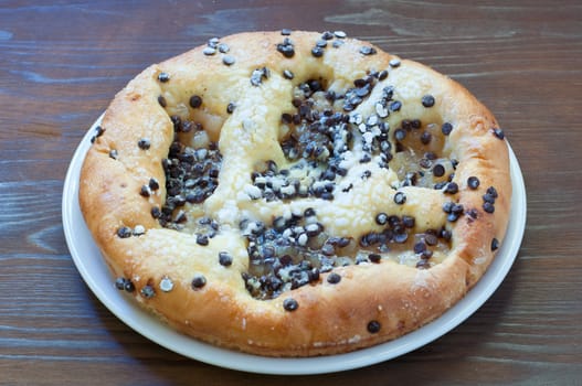 Sweet cake with chocolate chunks, cheese and powdered sugar