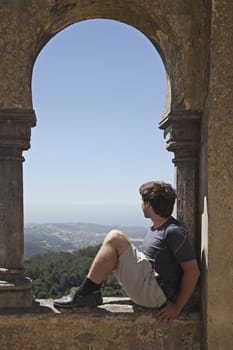 Young man in arabian arch of  Pena palace, Sintra