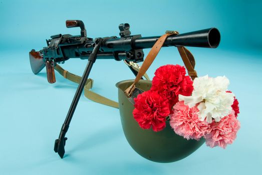 Old Russian machine gun and flowers