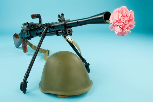 Old Russian machine gun and flowers