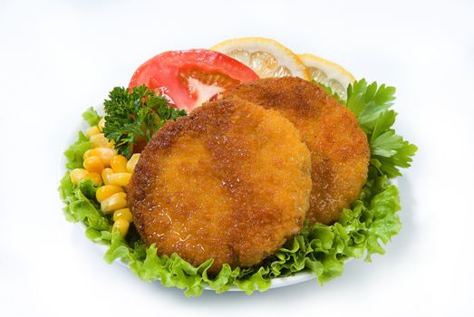 Cutlets with greenery, lemon, tomatoes and peas