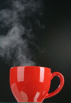 Red cup and smoke on a black background