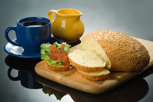 Still life with red caviar and cup of tea