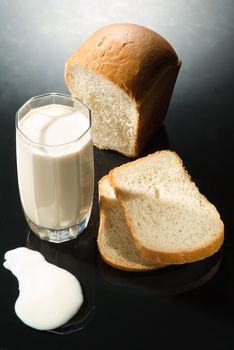 Bread and milk on a glass background