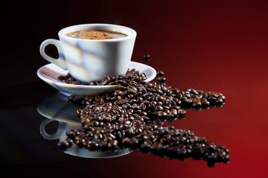 Coffee and beans on a glass studio background