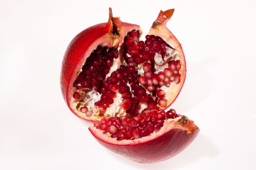 Crashed pomegranate on isolated studio background