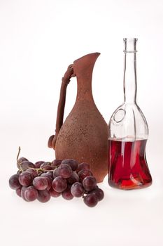 Still life with grape and ceramic jar on isolated background