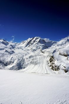 snow alps mountains vertical and blue sky, zermatt, switzerland