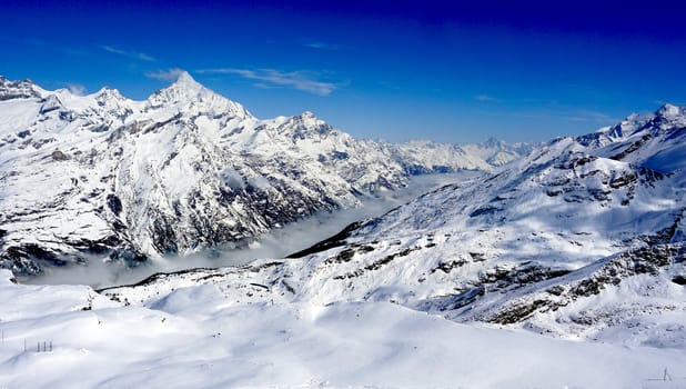 snow alps mountains and mist with blue sky, zermatt, switzerland