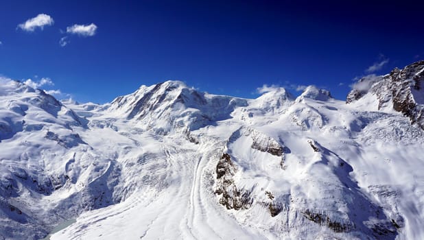 snow alps mountains with clouds, zermatt, switzerland