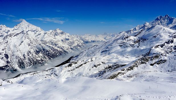 snow alps mountains view and mist with blue sky, zermatt, switzerland