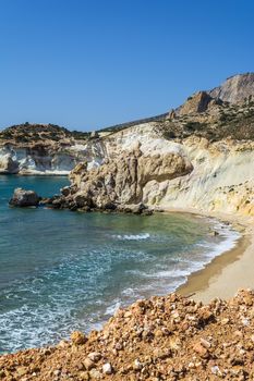 Golden beach and coastline with rocks at the Greek island of Milos