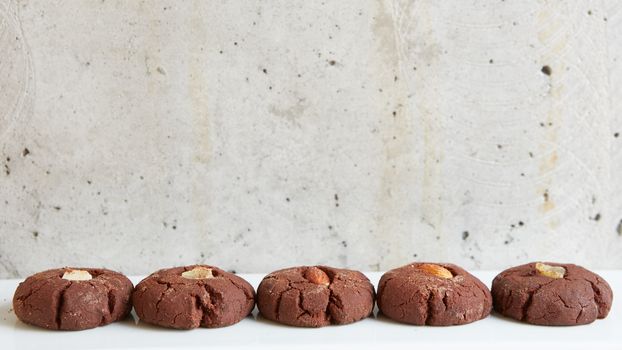 Chocolate cookies with nuts on gray background