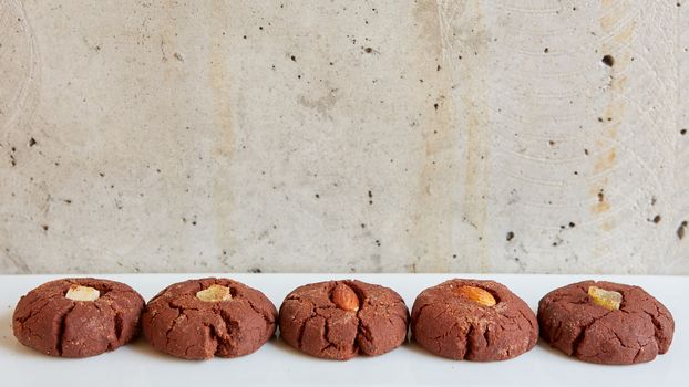 Chocolate cookies with nuts on gray background