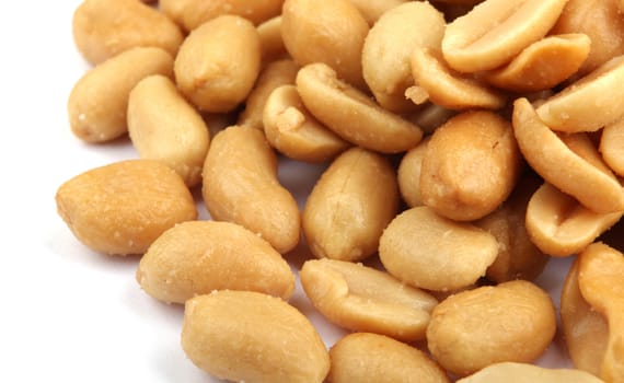 Close up of fried, peeled and salted peanuts.