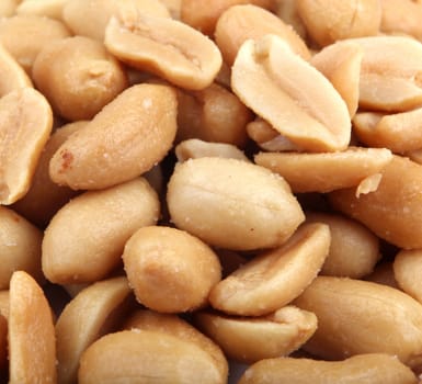Close up of fried, peeled and salted peanuts.