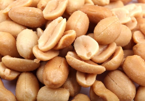 Close up of fried, peeled and salted peanuts.