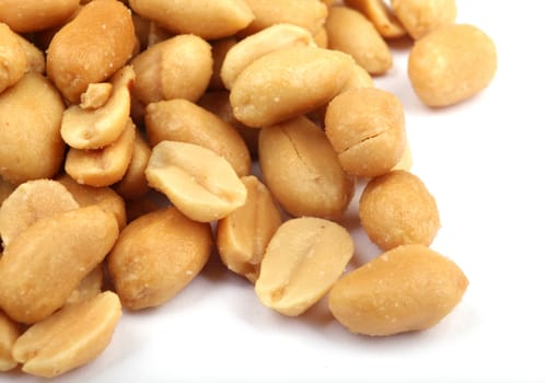 Close up of fried, peeled and salted peanuts.