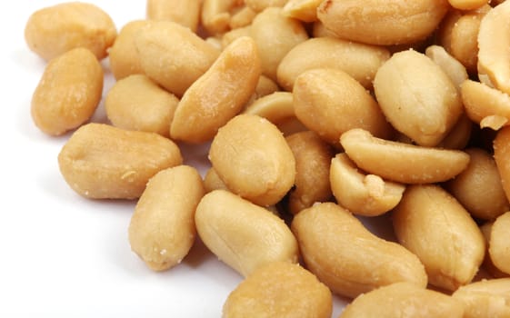 Close up of fried, peeled and salted peanuts.
