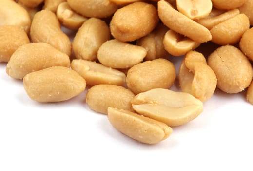 Close up of fried, peeled and salted peanuts.