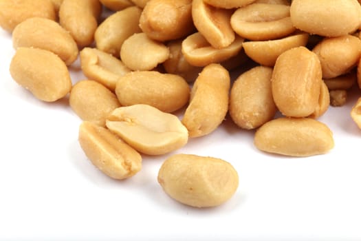Close up of fried, peeled and salted peanuts.