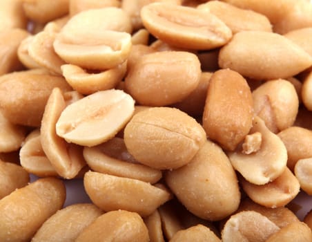 Close up of fried, peeled and salted peanuts.