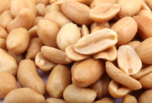 Close up of fried, peeled and salted peanuts.