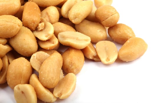 Close up of fried, peeled and salted peanuts.