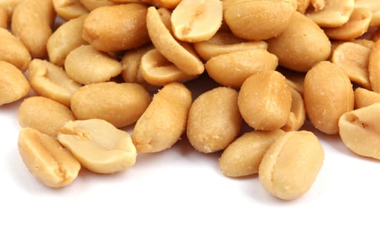 Close up of fried, peeled and salted peanuts.