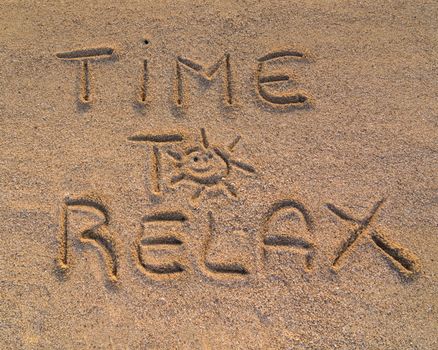In the picture the words on the sand "Time to relax"