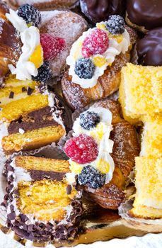 In the pictured typical italian pastries with cream,choccolate,rasperry and blackberry with various forms.