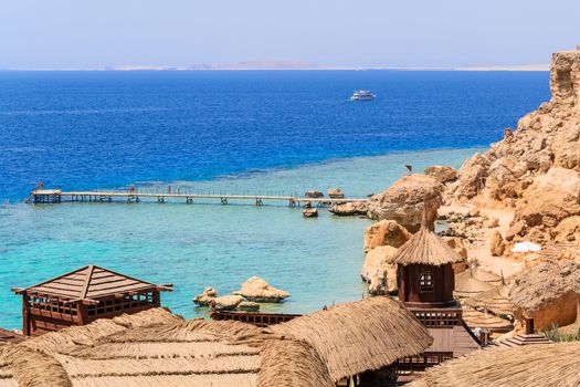 in the picture bungalow in wood and straw are located on the rock coast of the Red Sea in Egypt.