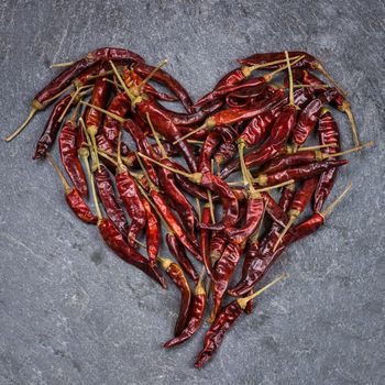 In the picture Italian chili peppers , arranged to form a red heart .