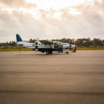 Two older airplanes in the Zanzibar airport at sunrise