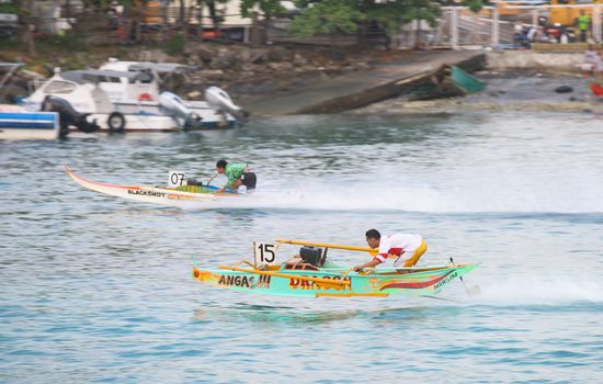 General Santos City, The Philippines - September 6, 2015: Two participants with their motorised outrigger boats at the bancarera race during the 17th Annual Gensan Tuna Festival 2015.