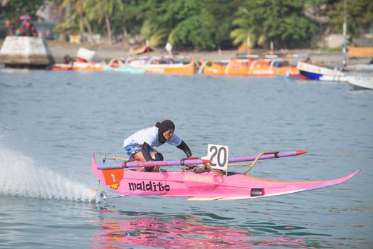 General Santos City, The Philippines - September 6, 2015: Participant with his outrigger boat at the bancarera race during the 17th Annual Gensan Tuna Festival 2015.