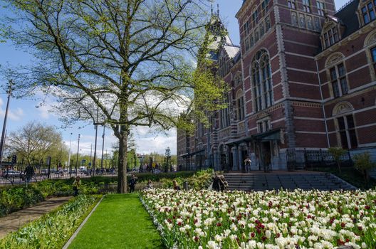 Amsterdam, Netherlands - May 6, 2015: Tourists at the garden around the Rijksmuseum, The Rijksmuseum is a Netherlands national museum dedicated to arts and history in Amsterdam.