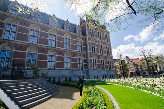 Amsterdam, Netherlands - May 6, 2015: Tourists at the garden around the Rijksmuseum, The Rijksmuseum is a Netherlands national museum dedicated to arts and history in Amsterdam.